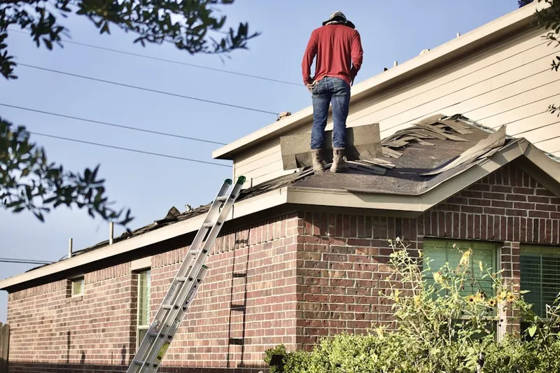 Professional roofer working on a residential roof in Brooklyn Park